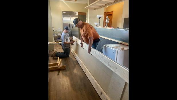 The late-night shipment of the counter tops, made for a long night for these two.