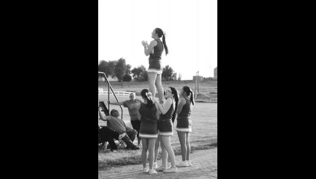 The JC cheerleaders have their first cheer session with some small pyramids.