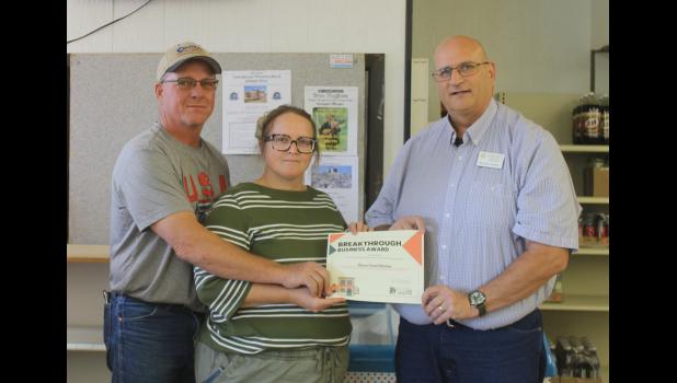 Charley and Lisa Harpster receive the award from Michael Steffen.
