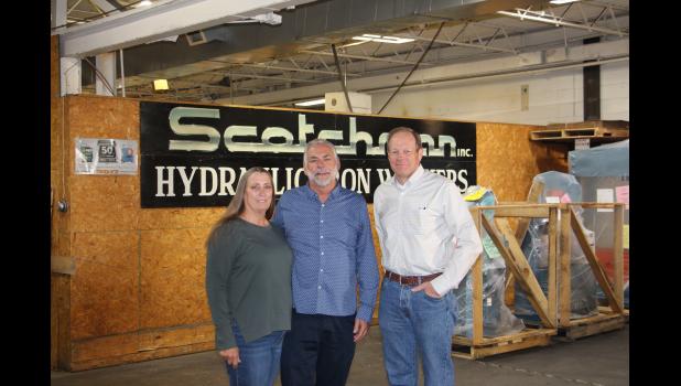 Karen and Jerry Kroetch stand in the shipping room of Scotchman Industries with new owner Kevin Allen.
