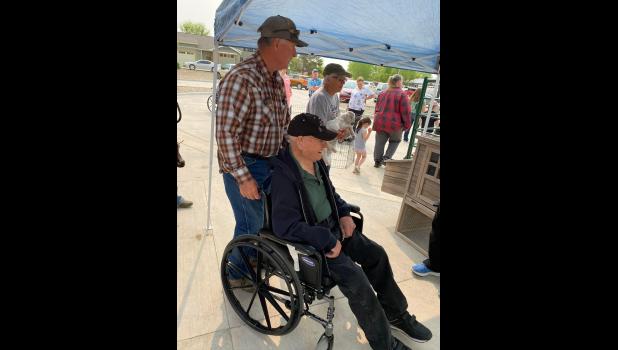 Resident Richard Smith (the Centers oldest resident at 105 years-young!) enjoying the Petting Farm while being escorted by a family member.