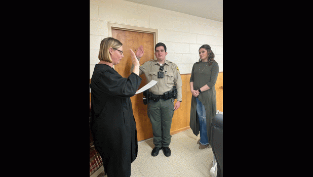 Sixth Circuit Court Judge Margo Northrup swears in JCSO Deputy Chauncey Hauptman. His wife, Mackenzie, as a witness to his pledge of service. Photo courtesy of Ronda Dennis