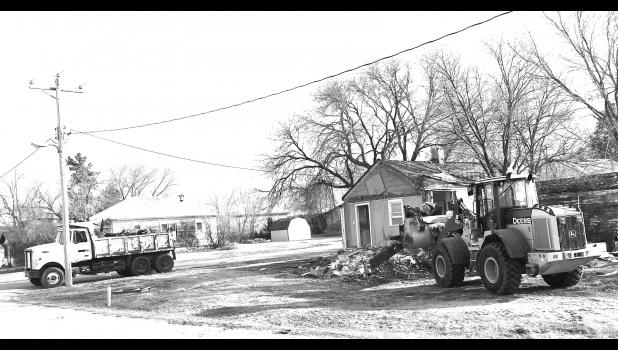 Another one bites the dust in Kadoka. City public works employees remove an uninhabitable structure at the intersection of Poplar Street and Fifth Avenue. In the last two years, a number of dilapidated and dangerous structures have been removed and paved the way for new construction through a Joint Powers Agreement between the city of Kadoka and the Jackson-Kadoka Economic Development Corporation. Elizabeth Meighen