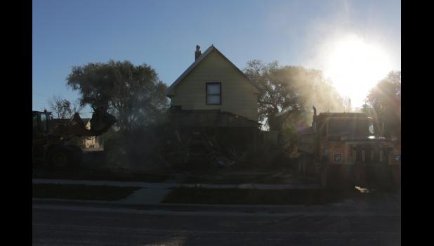 As the sun come up over the trees Monday morning, the city crew were clearing a lot that housed many families in Philip since 1906.
