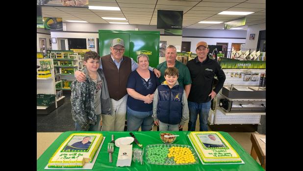 Barry Grossenburg and Charlie Grossenburg stand with Bobbi and Joe, along with Charlie’s two sons, just minutes before they begin serving the specially made picture cakes for the Woitte’s. Courtesy Photo