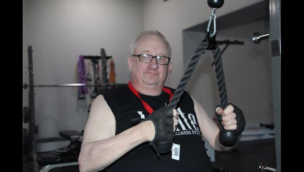 One of the workouts for Duane is pull downs with free weights on the back side of the machine. This exercise is one he now does for 22 minutes straight. He also uses the 1970s and 1980s music to help him stay motivated.