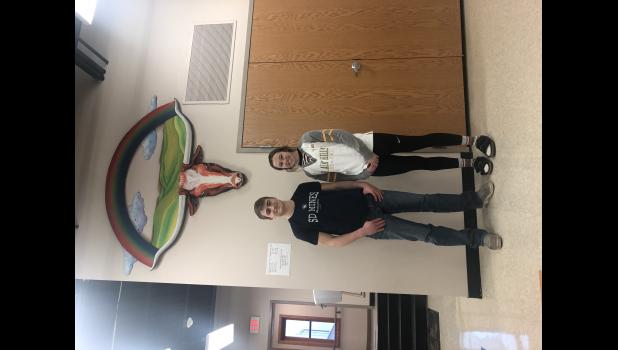 Joel Gifford and Aiyana Byrd ... sporting shirts of their college teams each will be joining when the fall semester of 2021 commences. Photo courtesy Miles Gifford