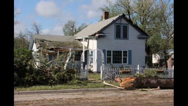 The Mark and Denise Coyle residence took on huge structural damage Saturday to house and yard along West Pine Street. Huge trees had to be removed.