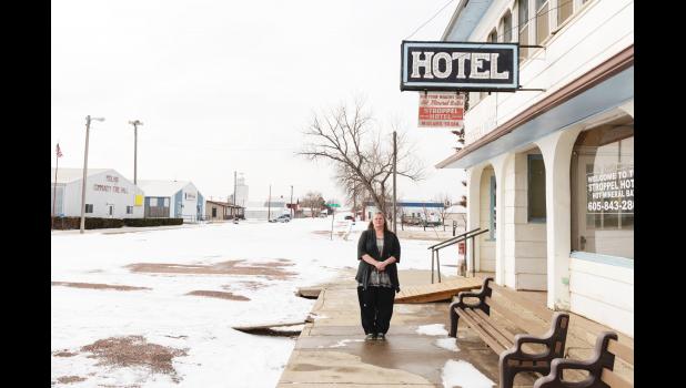 Laurie Cox stands in front of the Stroppel Hotel in Midland, South Dakota. Cox bought the two-story hotel in part to house the men and women who were hired to work on the Keystone XL pipeline. Todd Ellingson