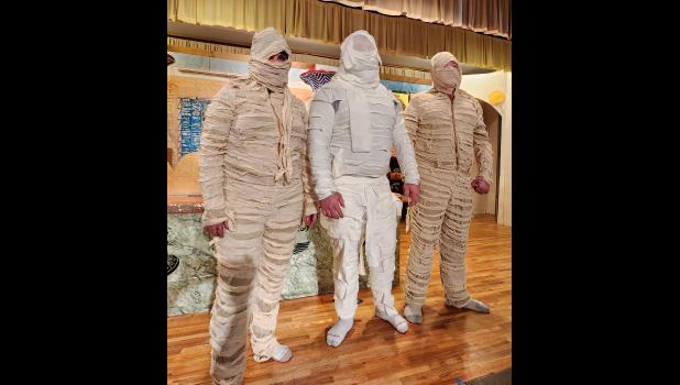 The three mummies in “How I Met Your Mummy” were never on the stage at the same time. Can you guess who they were when they were not wrapped up? Look in this paper for another photo with their identities revealed. Courtesy Photo