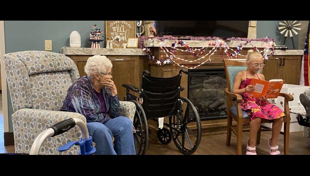 Izzy Formanek, youth volunteer entertaining residents while sharpening her reading skills as she read Dr. Seuss's Green Eggs and Ham.