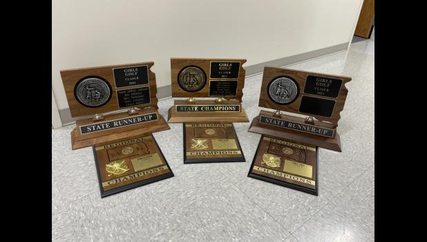 Region and State Plaques on display at the Bison School that this team has received.