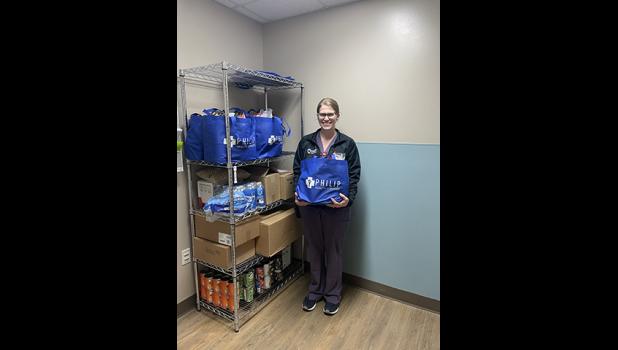 Health Equity Team Director, Haley Ehlers, and the Wellness Pantry provide a tote bag of nutritious food at the time of discharge for patients in need. Courtesy Photo