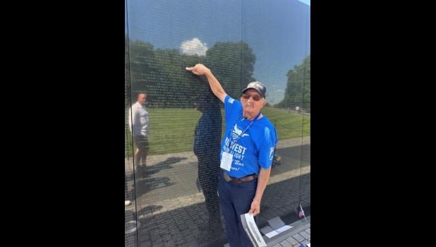 Philip Pearson at the Vietnam Memorial pointing to his classmate Richard Brech’s name. Courtesy Photo