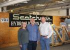 Karen and Jerry Kroetch stand in the shipping room of Scotchman Industries with new owner Kevin Allen.