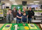Barry Grossenburg and Charlie Grossenburg stand with Bobbi and Joe, along with Charlie’s two sons, just minutes before they begin serving the specially made picture cakes for the Woitte’s. Courtesy Photo