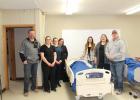 Friday, January 13, 2023, was the first day of learning in the classroom lab for three nursing students, attending Western Dakota Technical College nursing program. Standing over one of the three patient stations set up for instruction are (l to r): Jeff Rieckman, Superintendent of Haakon County School District; students, Marit Clawson, Sara Buls, and Mandy McGriff; WDTC Nursing Instructor, Sidney Dunker; WDTC Director of Nursing, Kristen Hybertson; and Brad Heltzel, WDTC board of trustees.