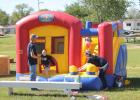 Two inflatables were set up for kids to have fun crawling around in, and sliding down during the fundraiser. Caysen Fromm is seen here making an exit from the smaller play zone.
