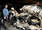 Lopez with the sculpture he is creating out of scrap metal.